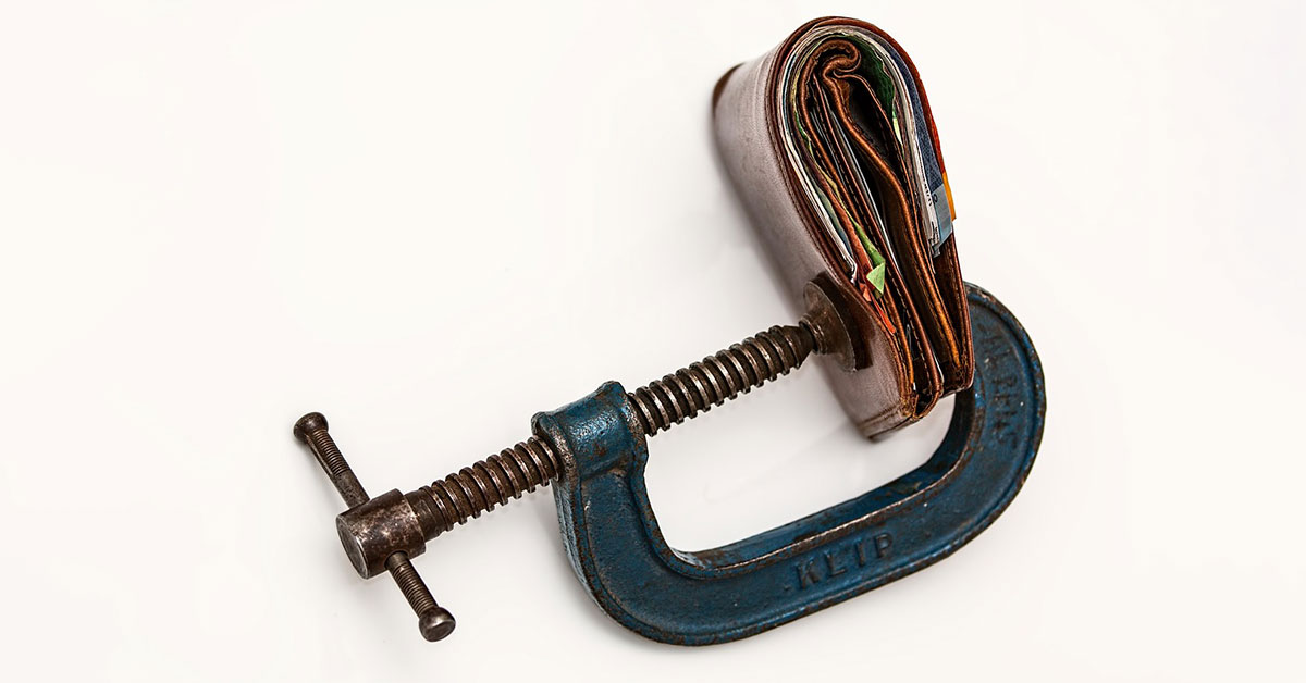 A wallet in a vise grip